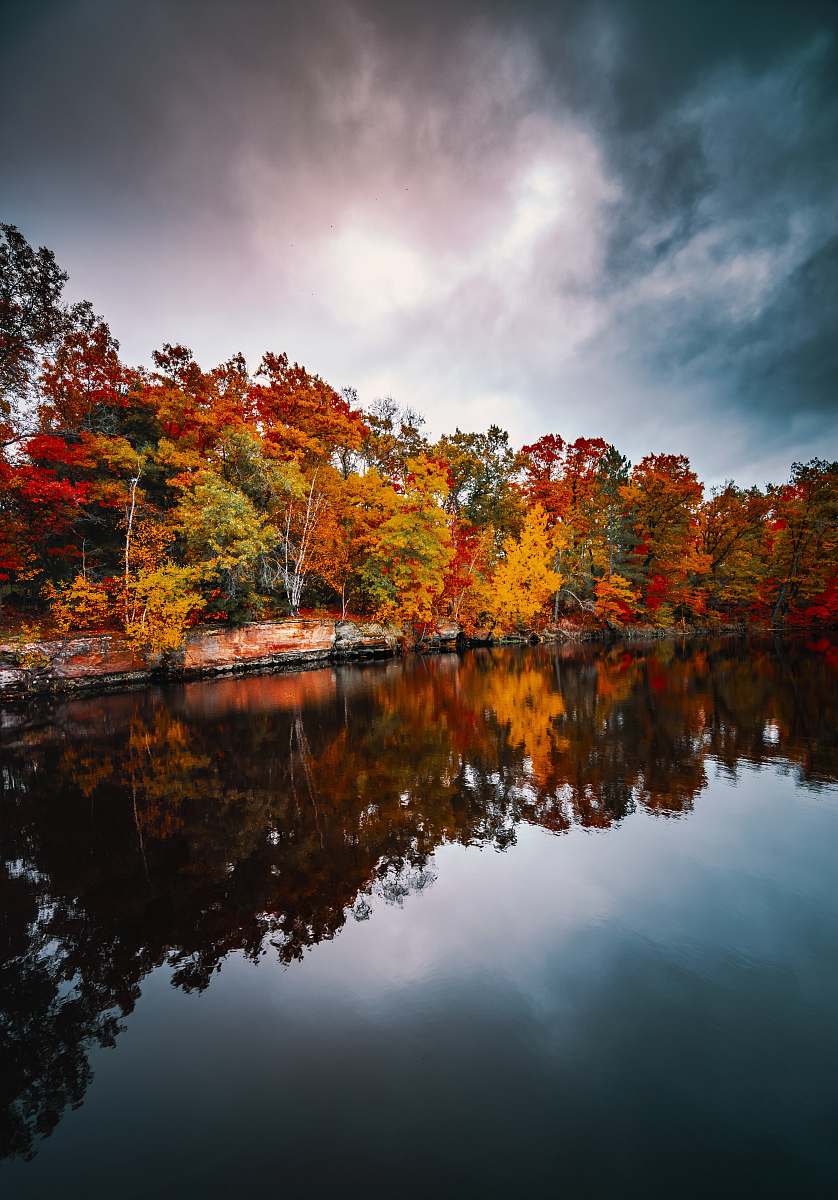 united states body of water surrounded by trees under gray sky brown